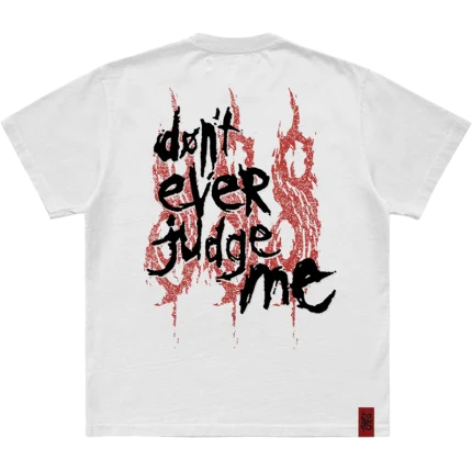 Make a statement with the 'Don't Ever Judge Me' Slipknot photo t-shirt. Featuring a powerful, striking image on the front and the 25th anniversary tribal S logo on the back, this black tee combines intense visuals with a tribute to Slipknot's legacy. Perfect for fans who stand strong and true. Grab yours today!