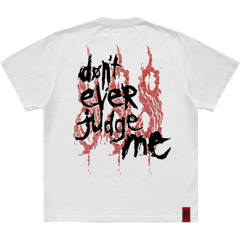 Make a statement with the 'Don't Ever Judge Me' Slipknot photo t-shirt. Featuring a powerful, striking image on the front and the 25th anniversary tribal S logo on the back, this black tee combines intense visuals with a tribute to Slipknot's legacy. Perfect for fans who stand strong and true. Grab yours today!