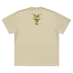 Tan t-shirt featuring a mask goat silhouette graphic with "Here Comes the Pain 25th Anniversary" on front and a goat silhouette on back