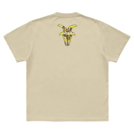 Tan t-shirt featuring a mask goat silhouette graphic with "Here Comes the Pain 25th Anniversary" on front and a goat silhouette on back